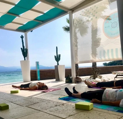 Morning yoga at a renowned lido in front of Lake Garda