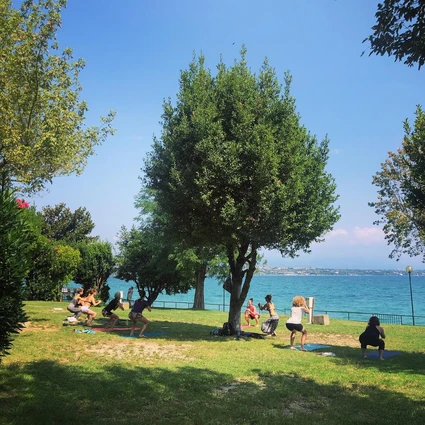Yoga group lesson outdoors with a view on Lake Garda 5