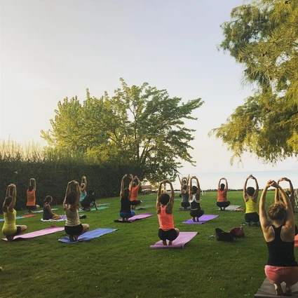 Yoga group lesson outdoors with a view on Lake Garda 18
