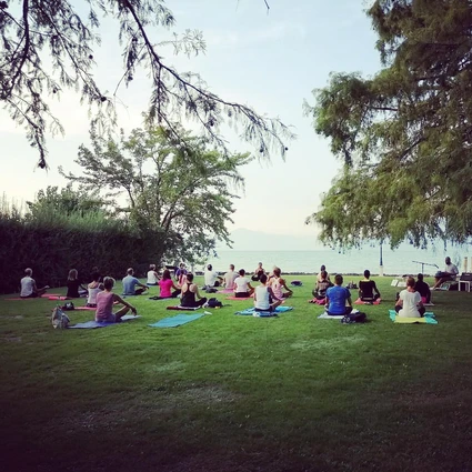 Yoga group lesson outdoors with a view on Lake Garda 24